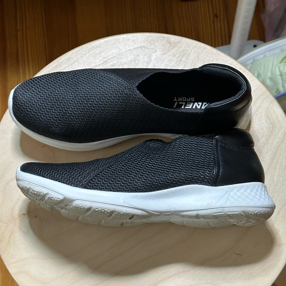 Woman’s black slip on sneakers.